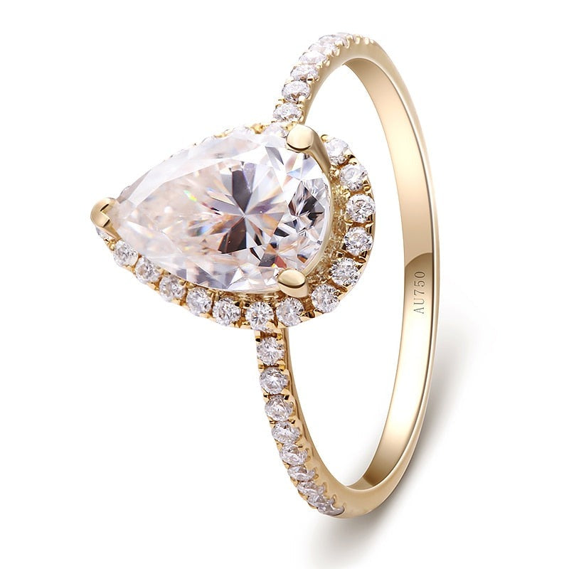 Solid yellow gold tear drop cut moissanite halo engagement ring.