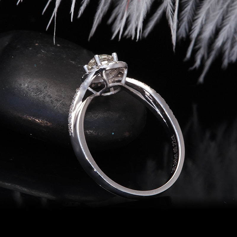 A silver round halo ring with a half pave split shank twisted band.