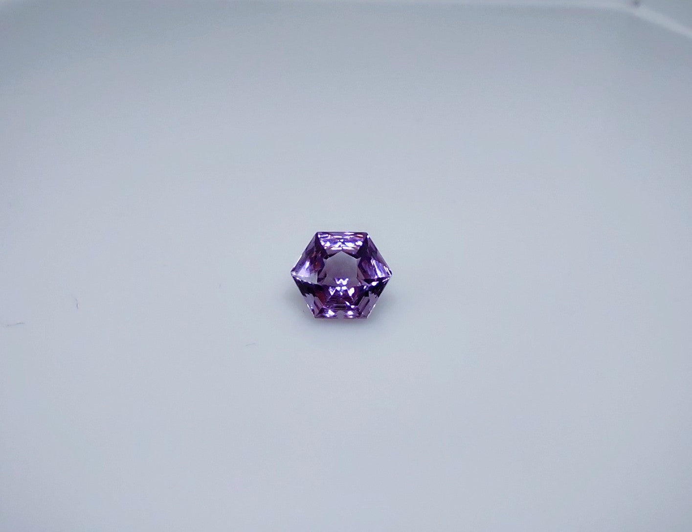 A spider web cut octagonal purple amethyst.