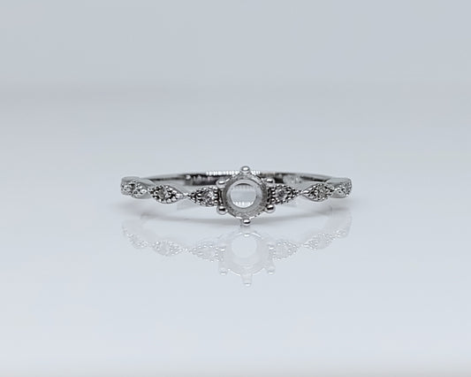 A silver semi mount vintage scalloped style setting for a round gem.