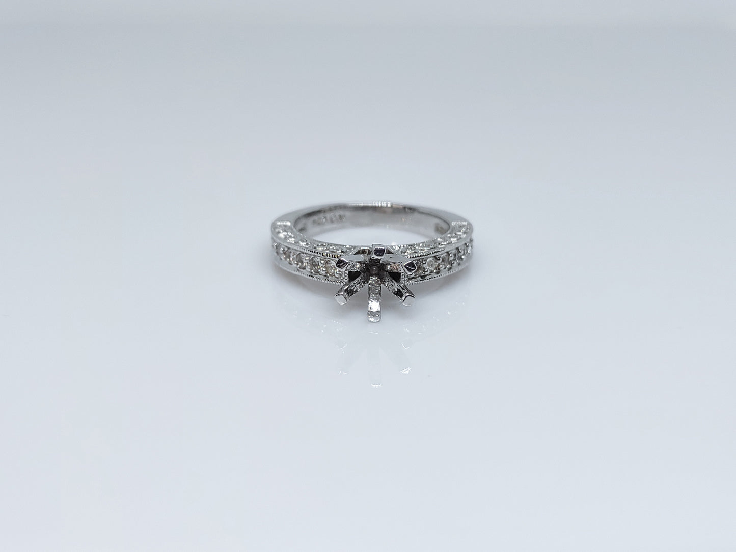 A silver pave banded semi mount with infinity filigree design on each side of the shank.