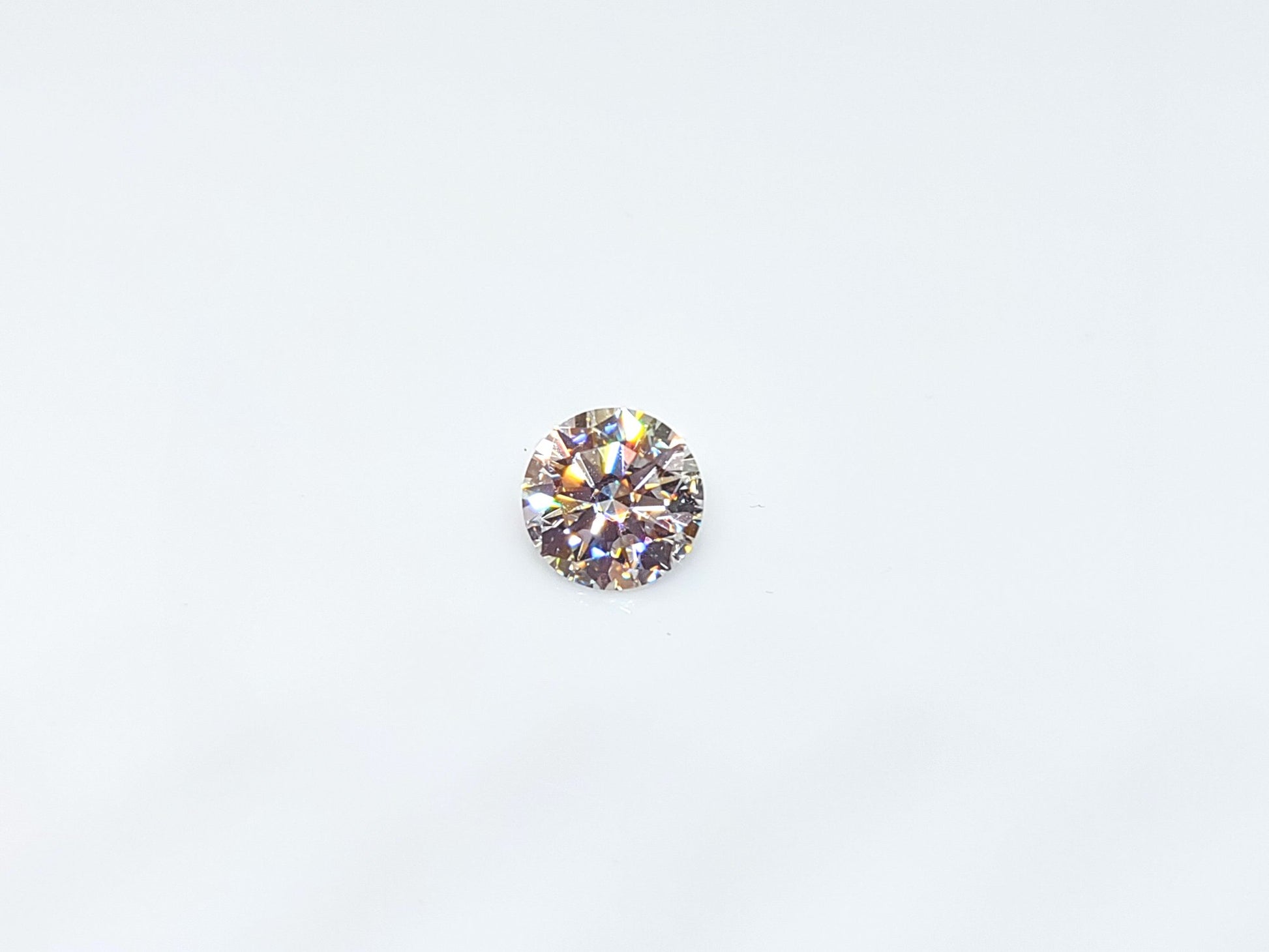 A round brilliant cut moissanite gem.