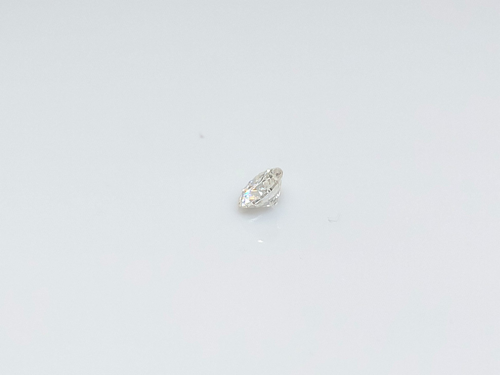 A round brilliant cut moissanite gem.