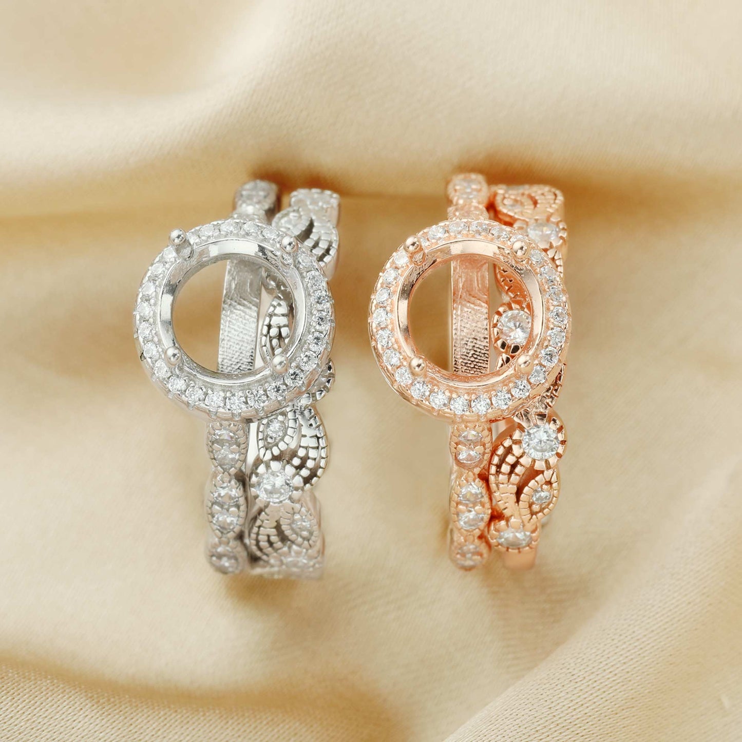 One silver and one rose gold art deco style halo semi mount with a filigree wave and gem studded design wedding bands.