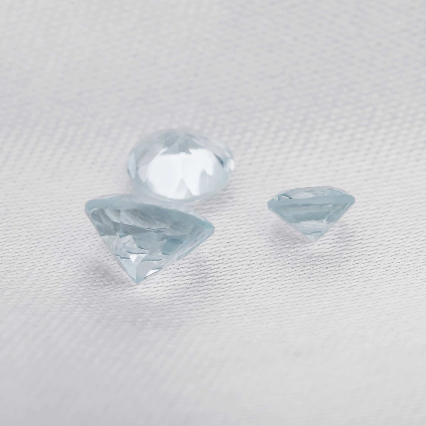 3 round cut light blue aquamarine gems.
