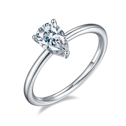 A silver solitaire set with a tear drop moissanite.