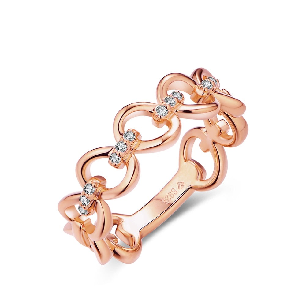 A rose gold chain link ring with 3 small moissanites connecting each link.