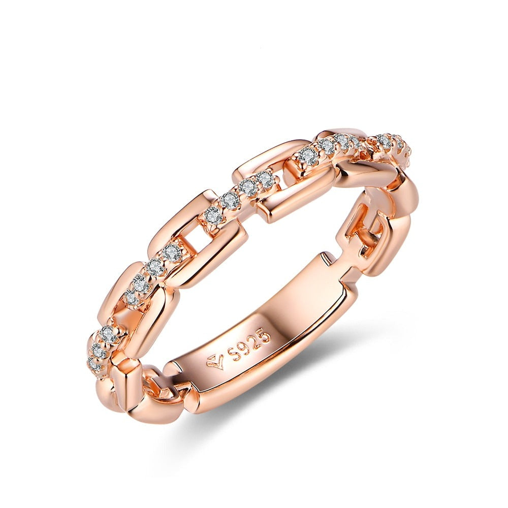 A rose gold D link ring with moissanite studded connectors.