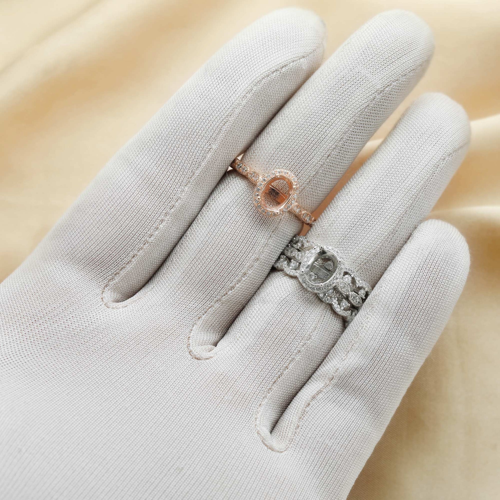 A hand wearing a silver 3 Piece wedding semi mount set  and rose gold halo engagement ring.