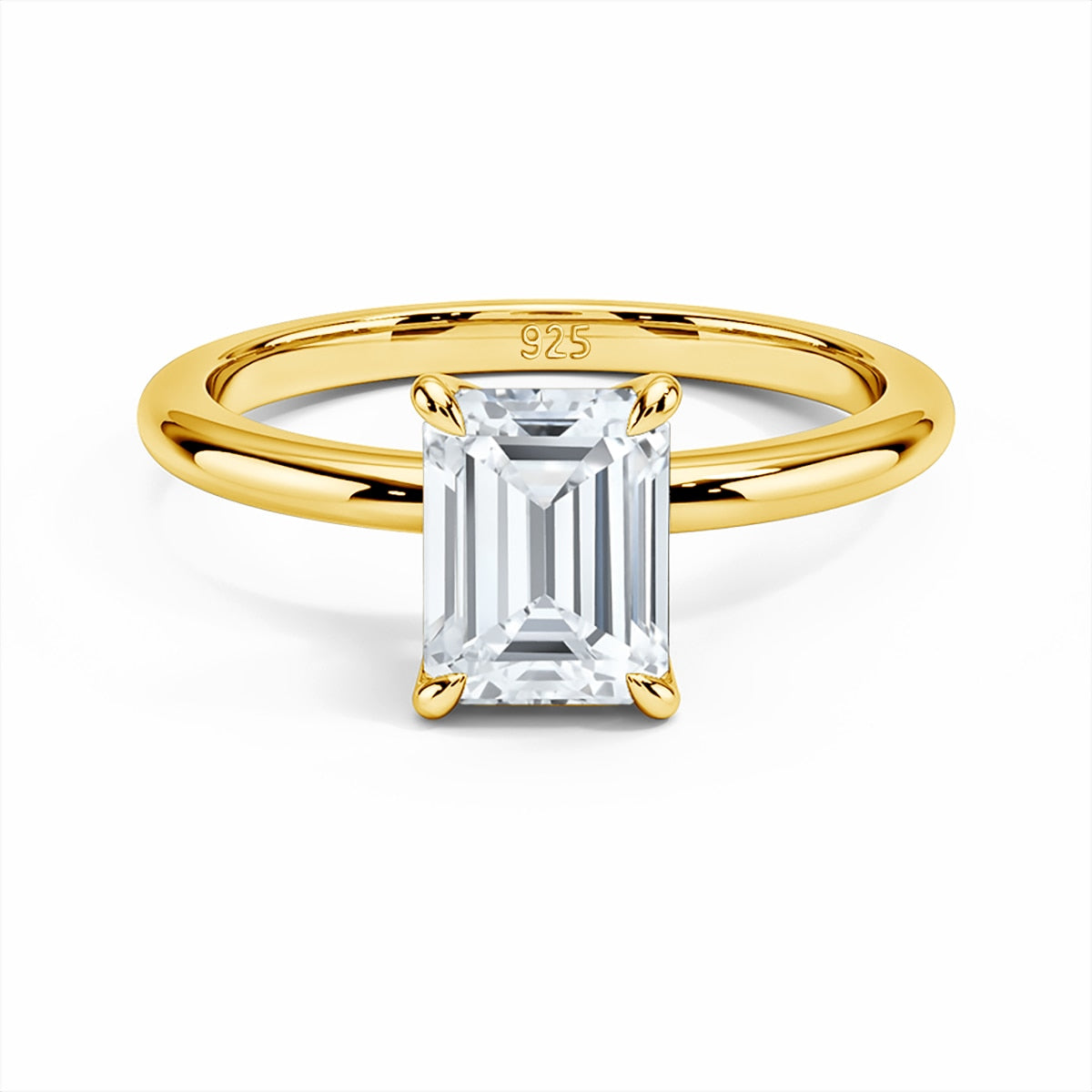 A gold band set with a 3CT emerald cut moissanite in petal style prongs.