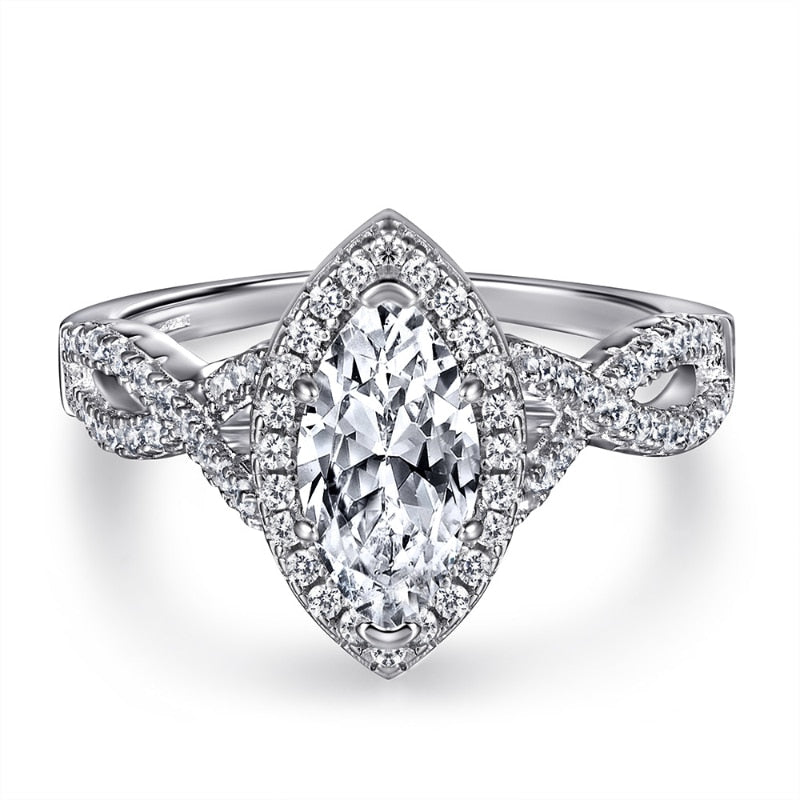 A silver engagement and wedding ring set with a marquise halo twisted band.