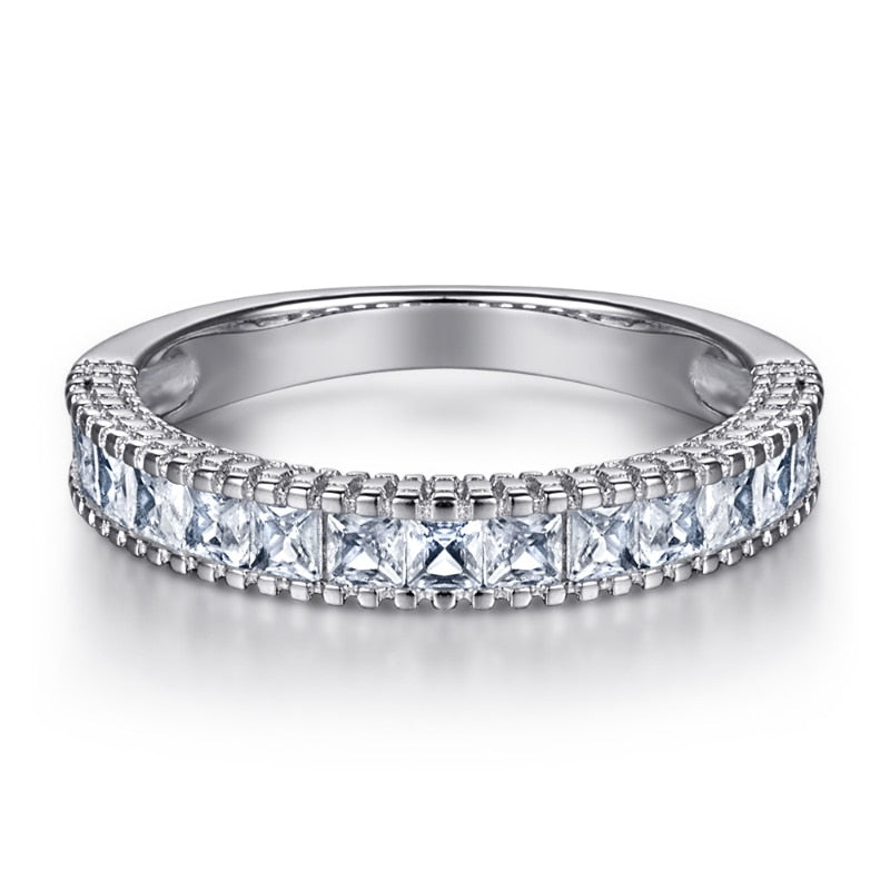 A silver wedding half infinity band set with princess cut gems.