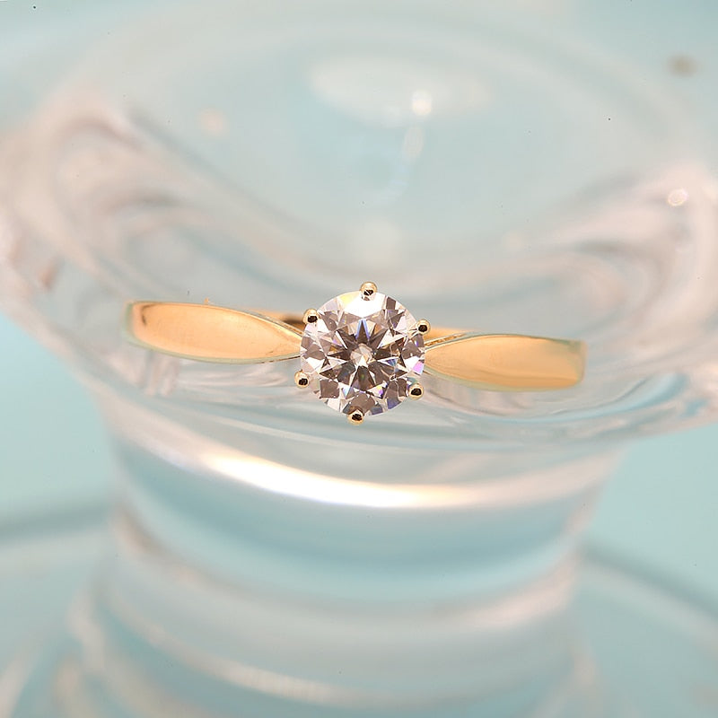 A gold small round solitaire with a tapered band.