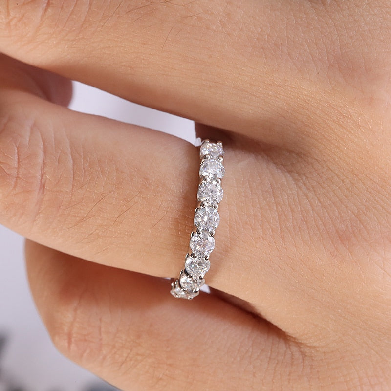 A silver half eternity wedding ring.