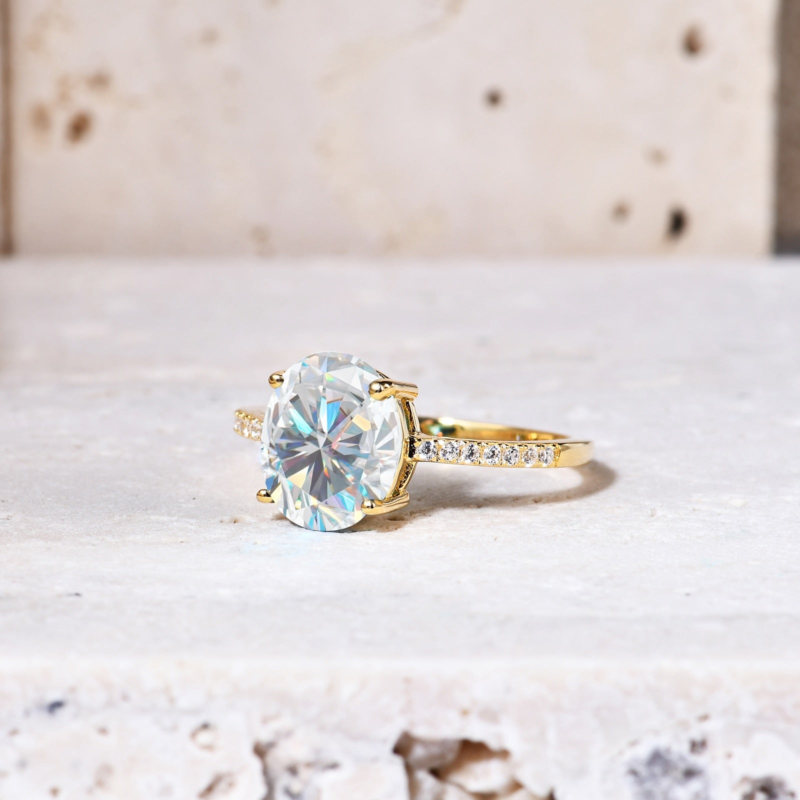 A gold pave band with moon and star cut outs on each side, set with a 3CT oval moissanite.