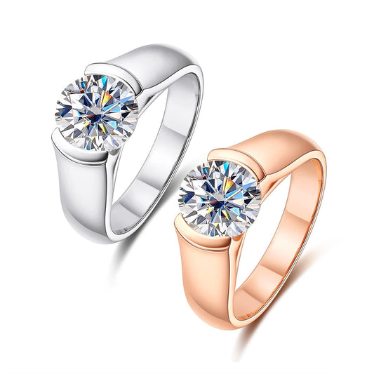 A white gold plated and rose gold plated round cut moissanite tension set in a floating half bezel setting.