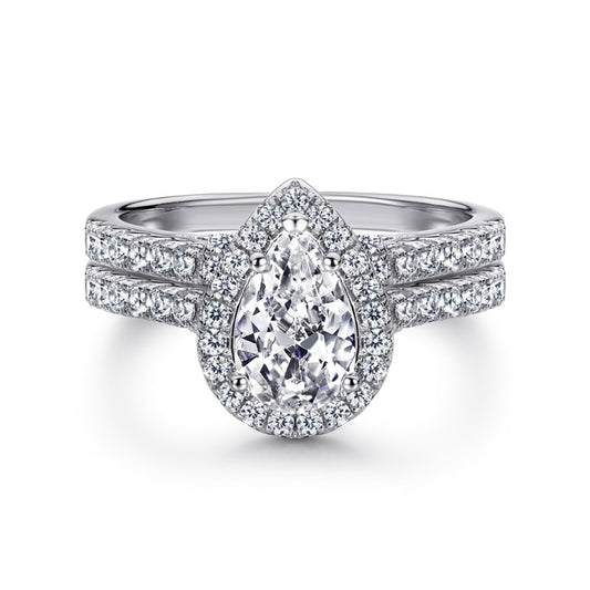 A silver pear cut moissanite halo ring with a matching pave wedding ring.