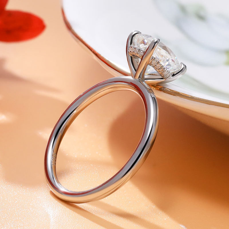 A silver oval cut hidden halo engagement rings.