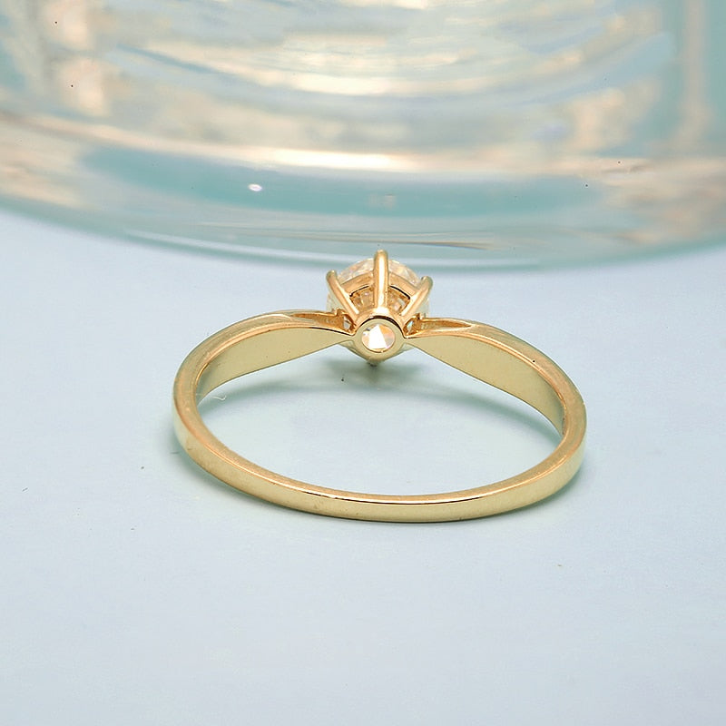 A gold small round solitaire with a tapered band.