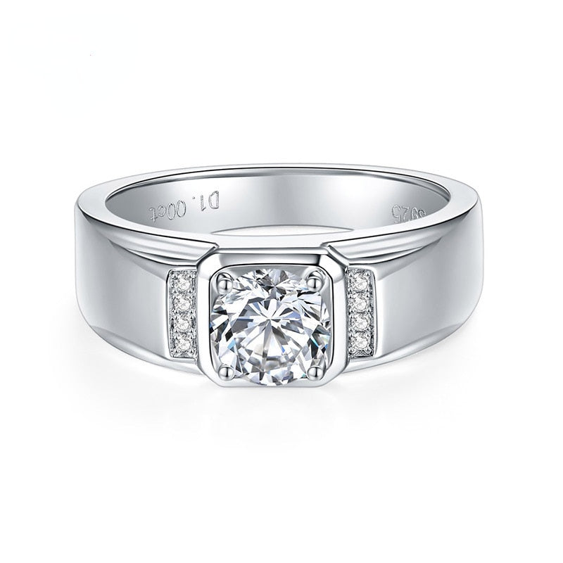 A silver thick banded ring set with a raised round moissanite and 4 sparkling gems on either side.
