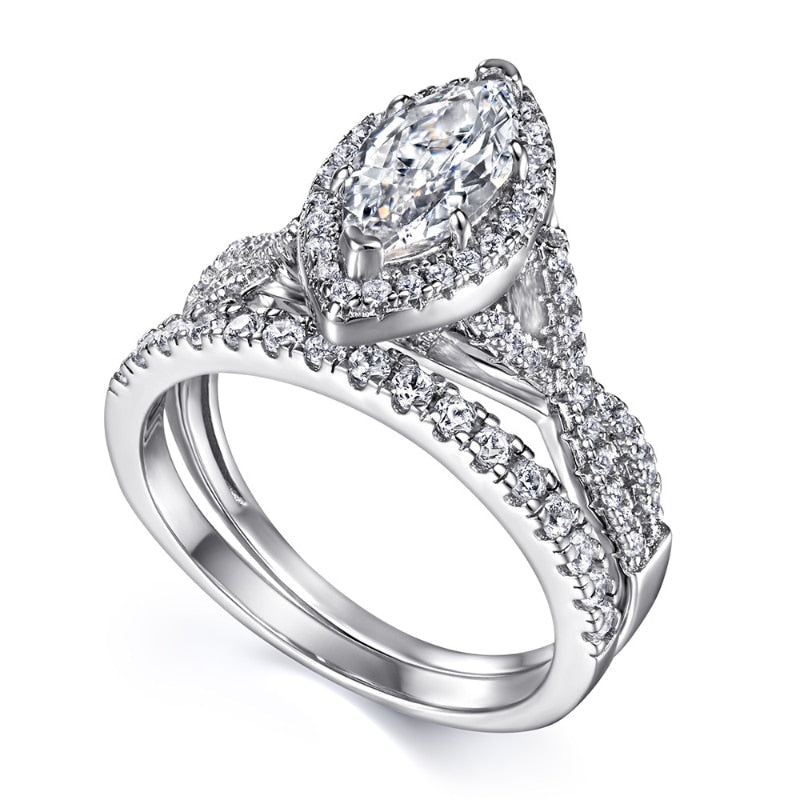 A silver engagement and wedding ring set with a marquise halo twisted band and eternity ring.