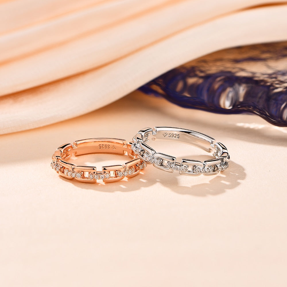  One rose gold and one silver D link rings with moissanite studded connectors.