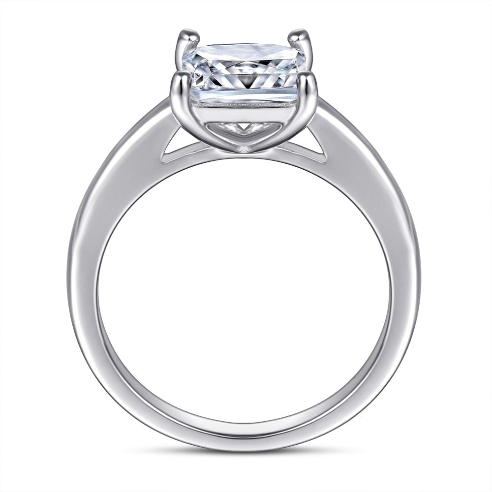 A silver ring set with a princess moissanite.