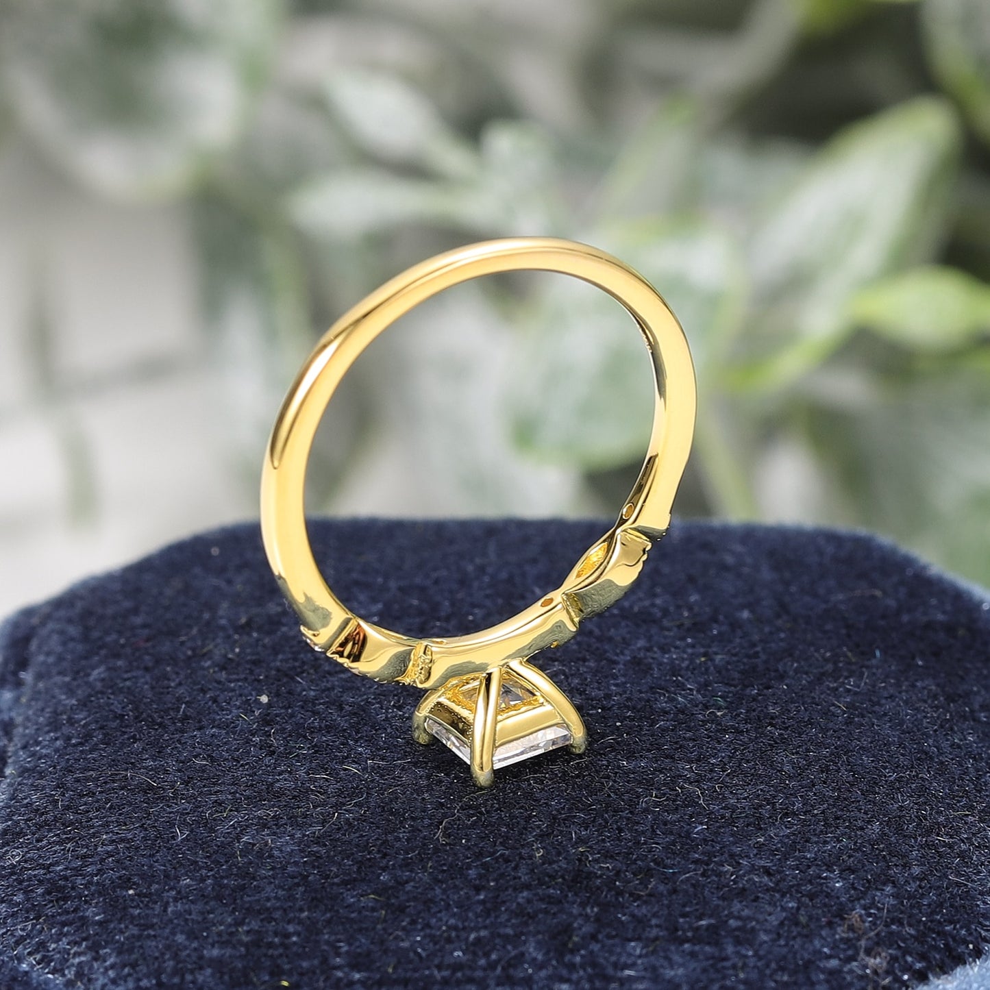 A gold art deco princess cut moissanite engagement ring.