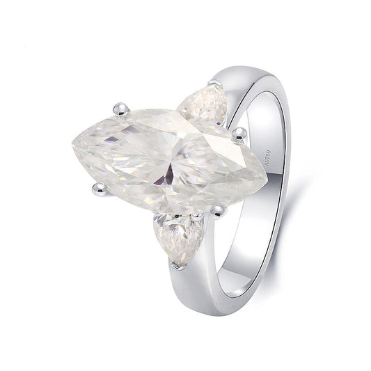 Solid white gold marquise cut moissanite 3 stone engagement ring with tear drop accents on each side.