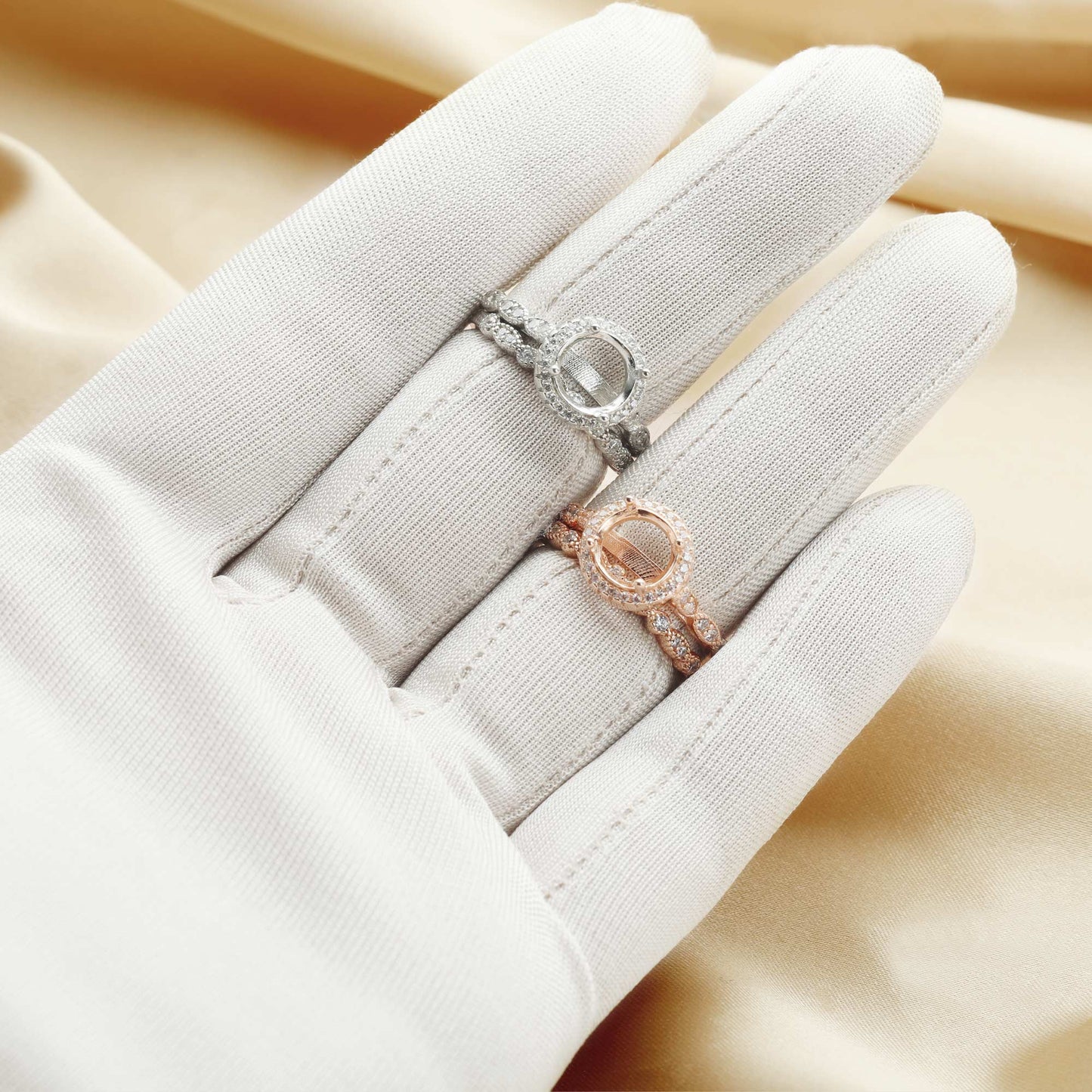 One silver and one rose gold art deco scalloped halo semi mount with matching art deco bands.