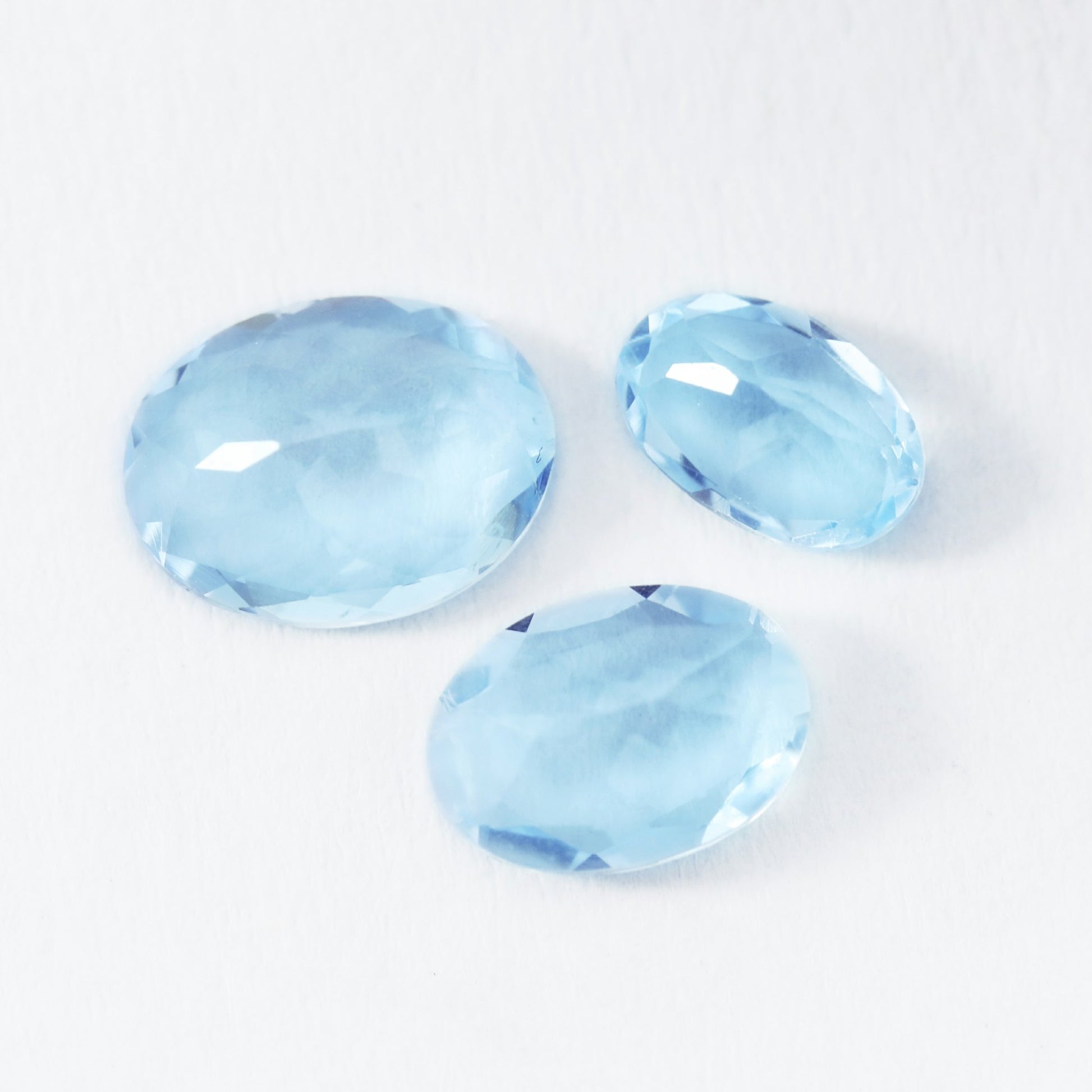 3 light blue oval aquamarine gems.