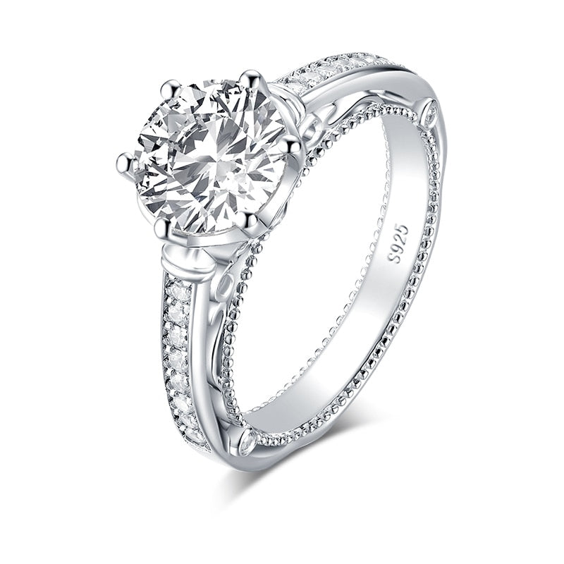 Silver filigree engagement ring with a round cut moissanite.