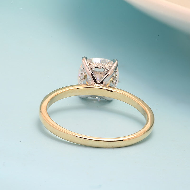 Solid yellow gold round cut moissanite hidden halo engagement ring.