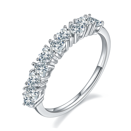 A silver half eternity wedding ring set with several heart cut moissanites set in alternating directions.