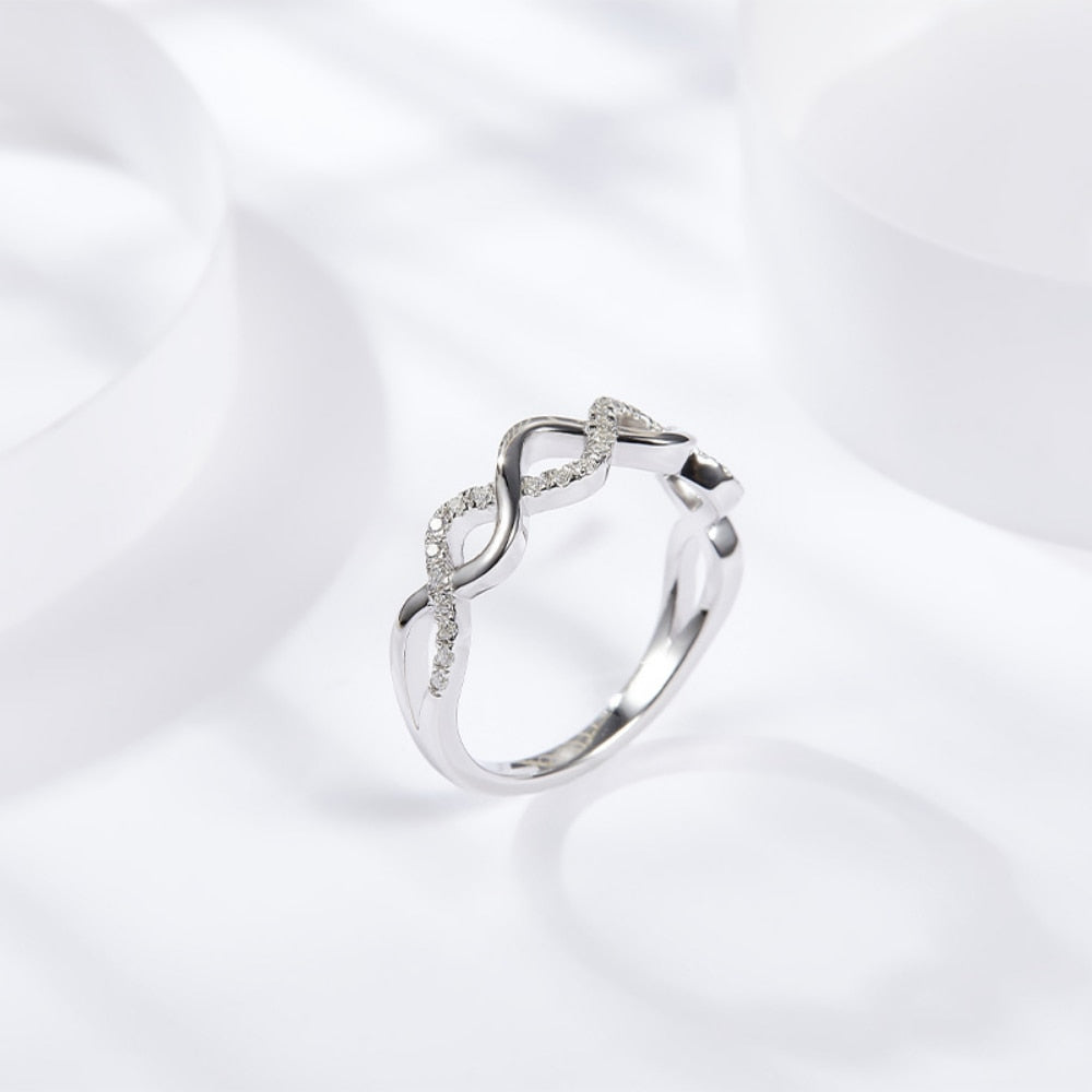 A silver half silver pave and half plain silver  twisted into a stackable ring.