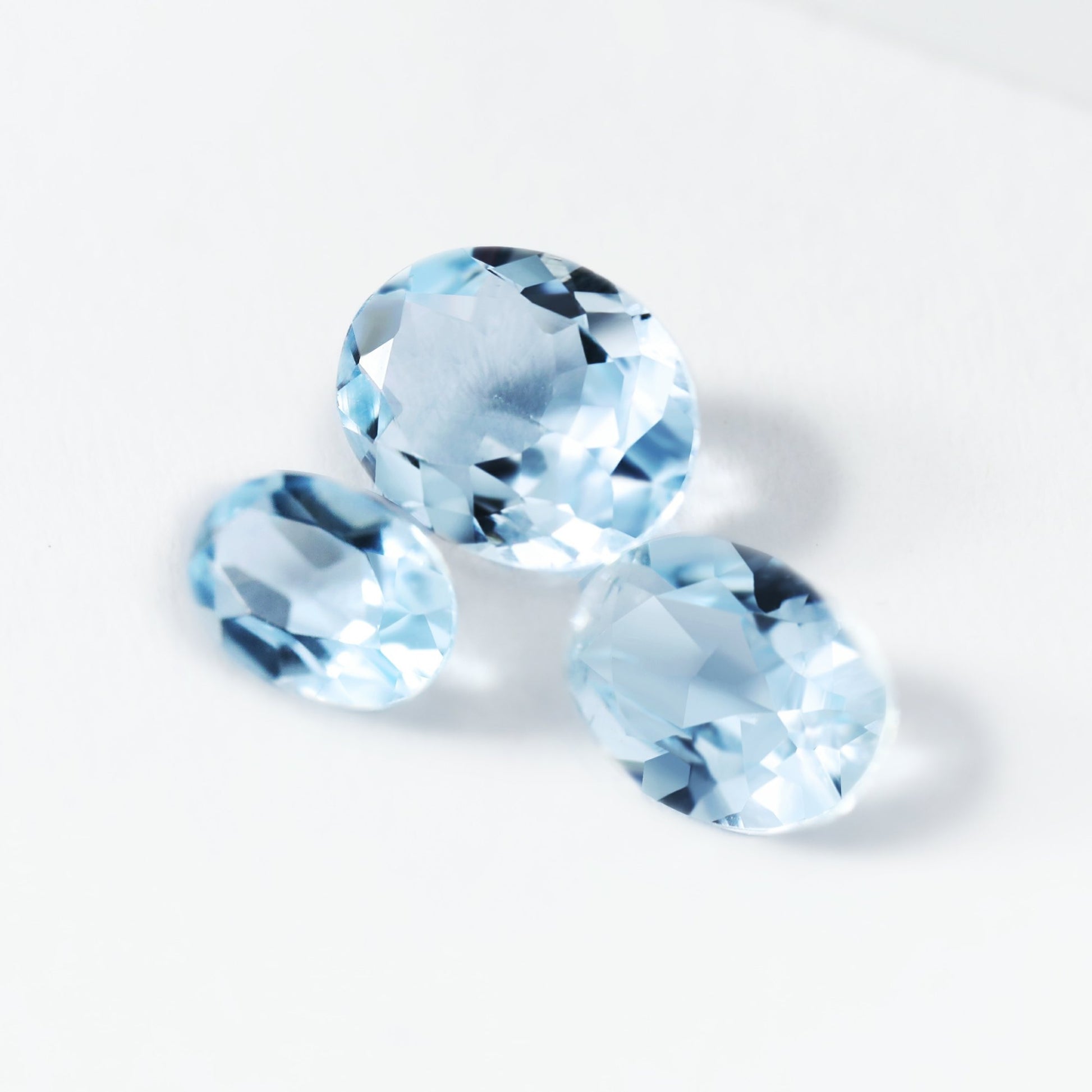3 light blue oval aquamarine gems.
