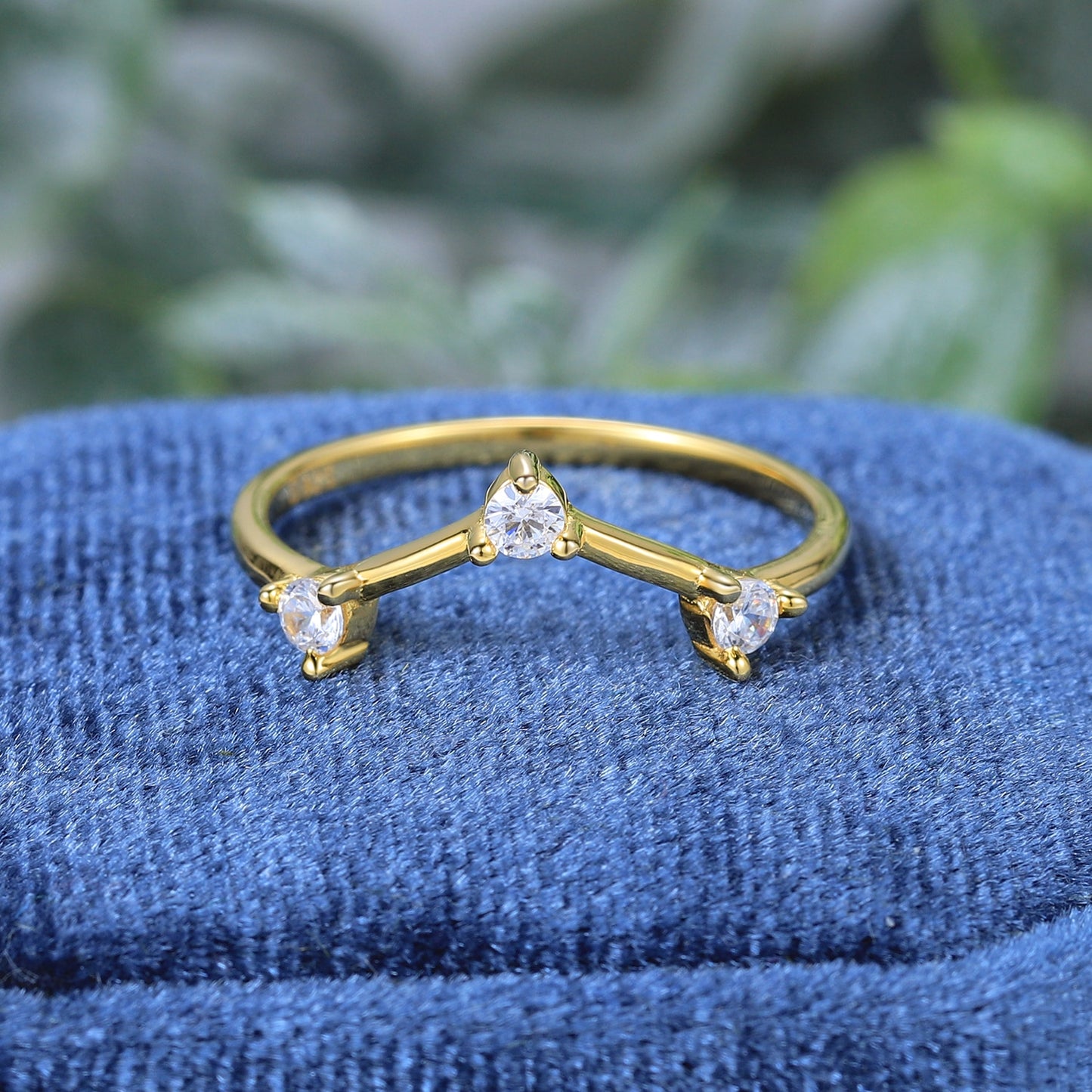 A gold 3 stone chevron style wedding ring.