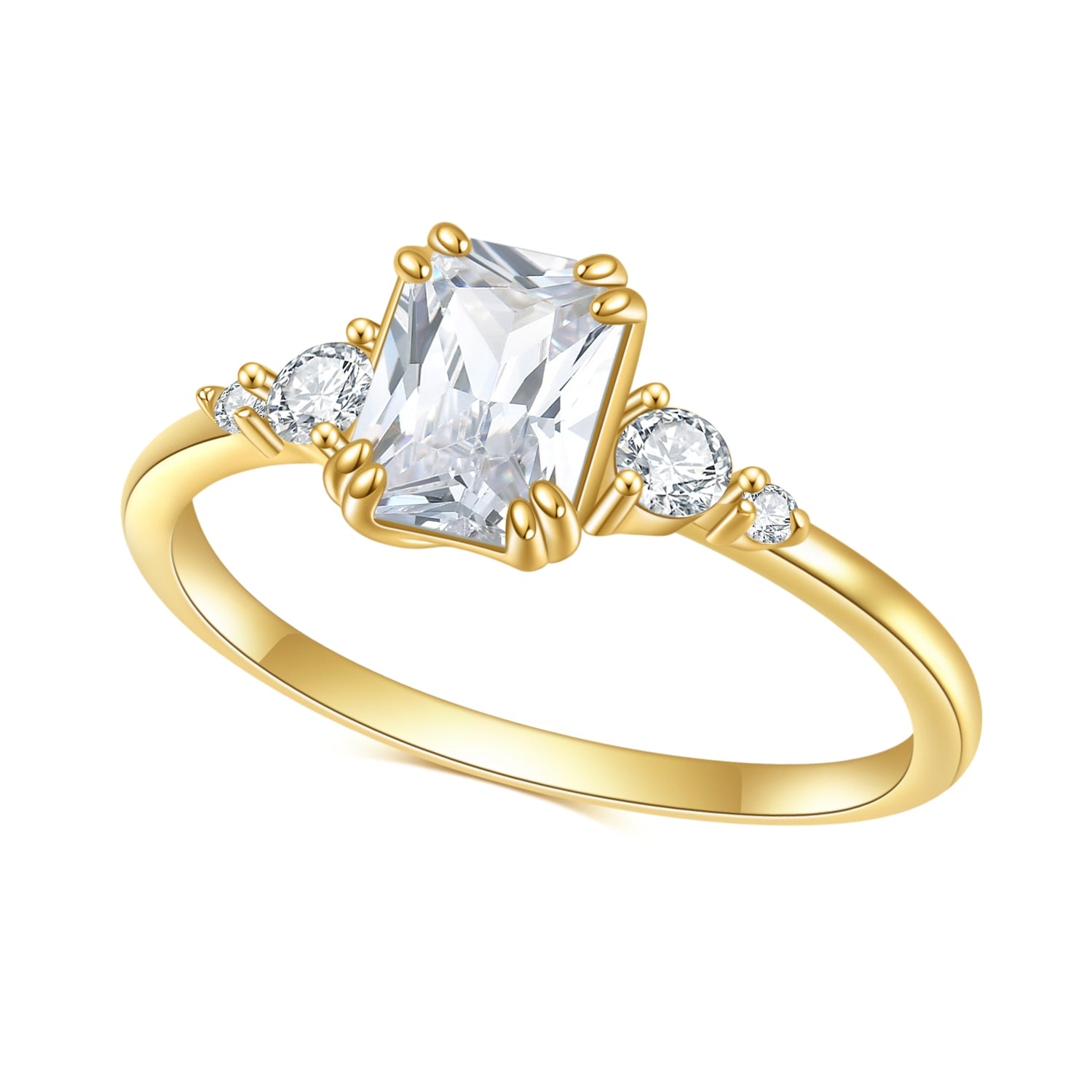 A gold ring set with a radiant cut moissanite with zircons on both sides.