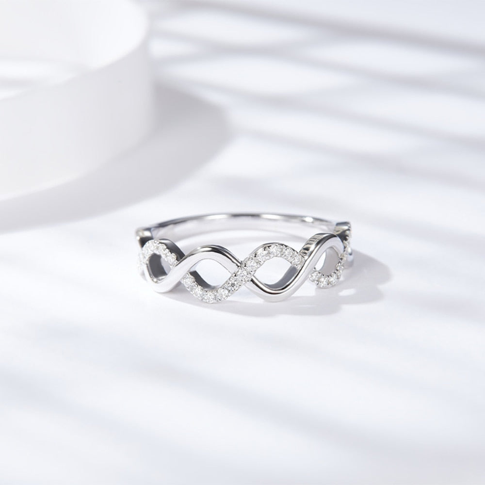 A silver half silver pave and half plain silver  twisted into a stackable ring.