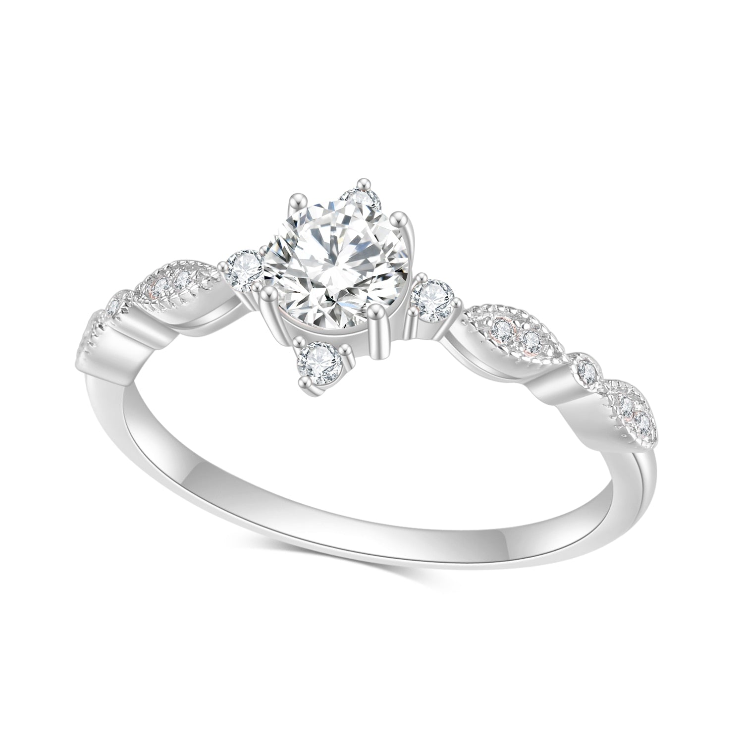 A silver vintage inspired engagement ring set with a round moissanite and 4 small zircons on all four sides.