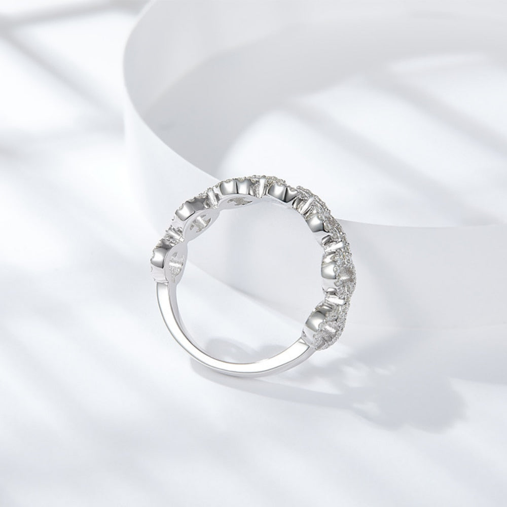 A silver round chain link style ring set with moissanites.