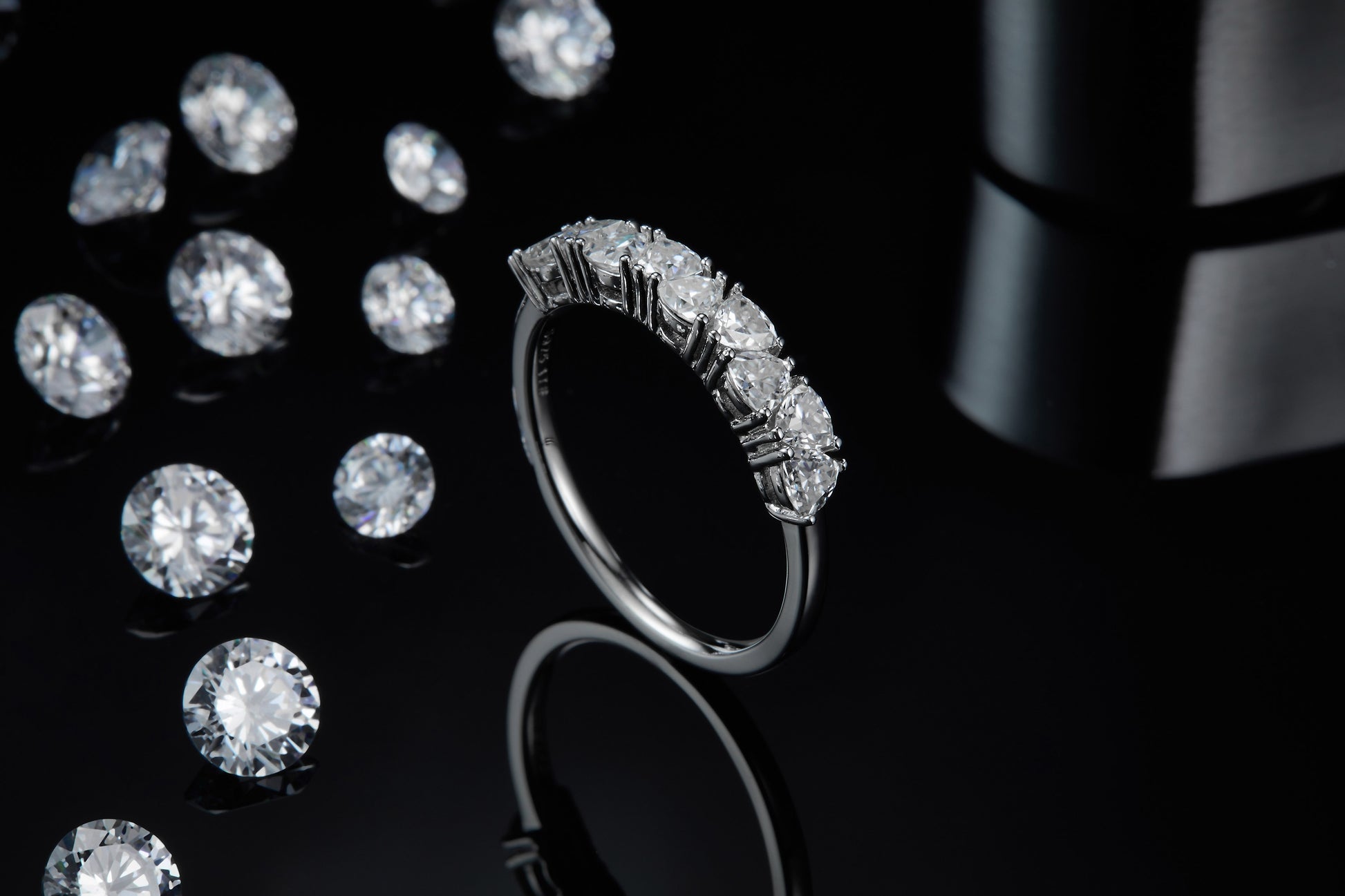 A silver trillion cut half eternity wedding ring.