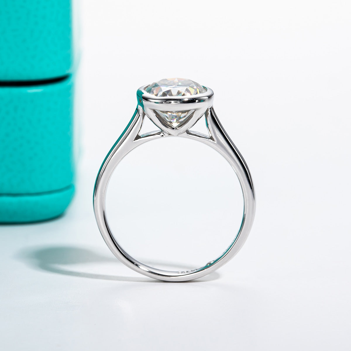 3CT oval cut moissanite set in a sterling silver bezel style setting.