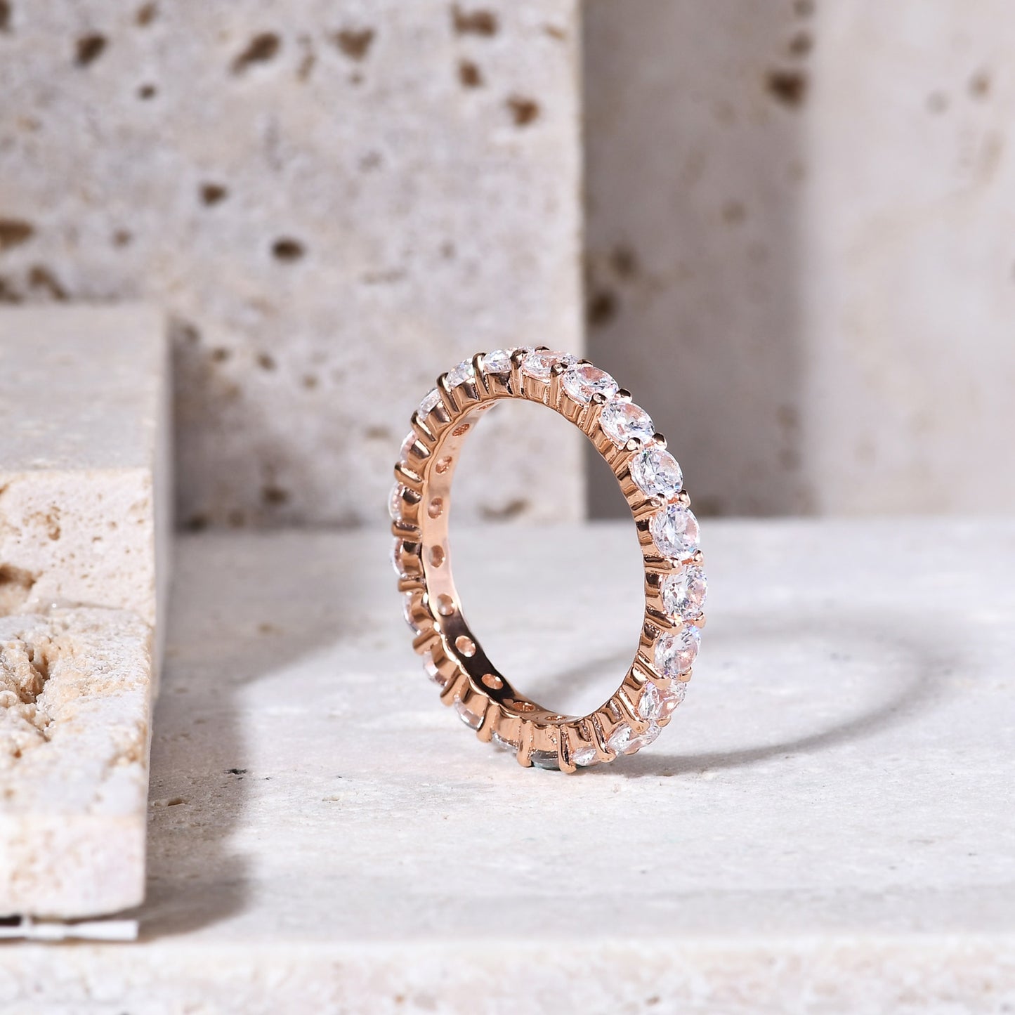 A rose gold moissanite infinity ring.