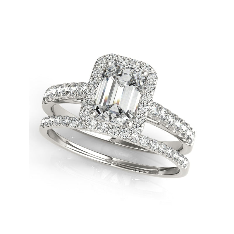 A silver engagement and wedding set with a  emerald cut halo ring and matching eternity band.