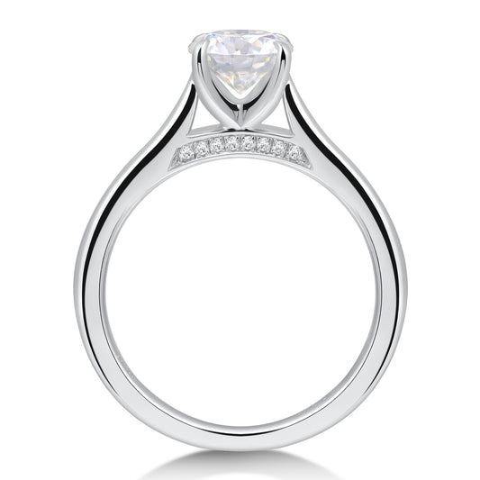 A silver bridge embellished cathedral set round engagement ring.