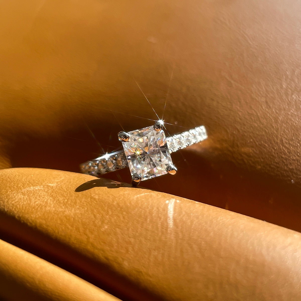 A sterling silver radiant cut moissanite set in a moissanite hidden halo and pave band.