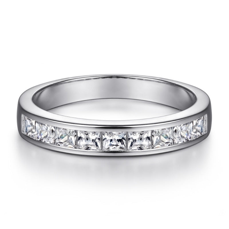 A silver band with small princess cut zircons channel set in the shank.