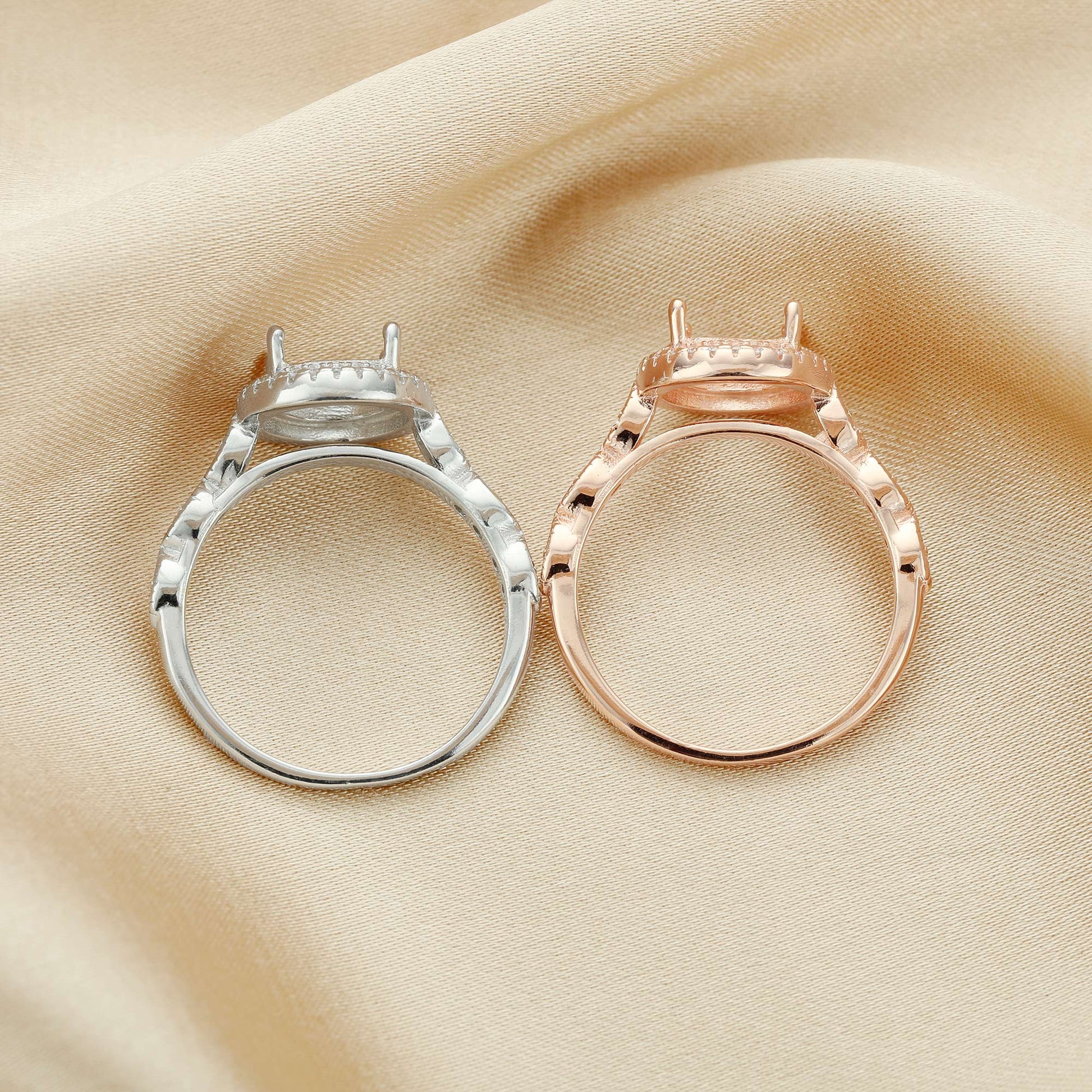 A silver round halo art deco style semi mount and a identical rose gold semi mount.