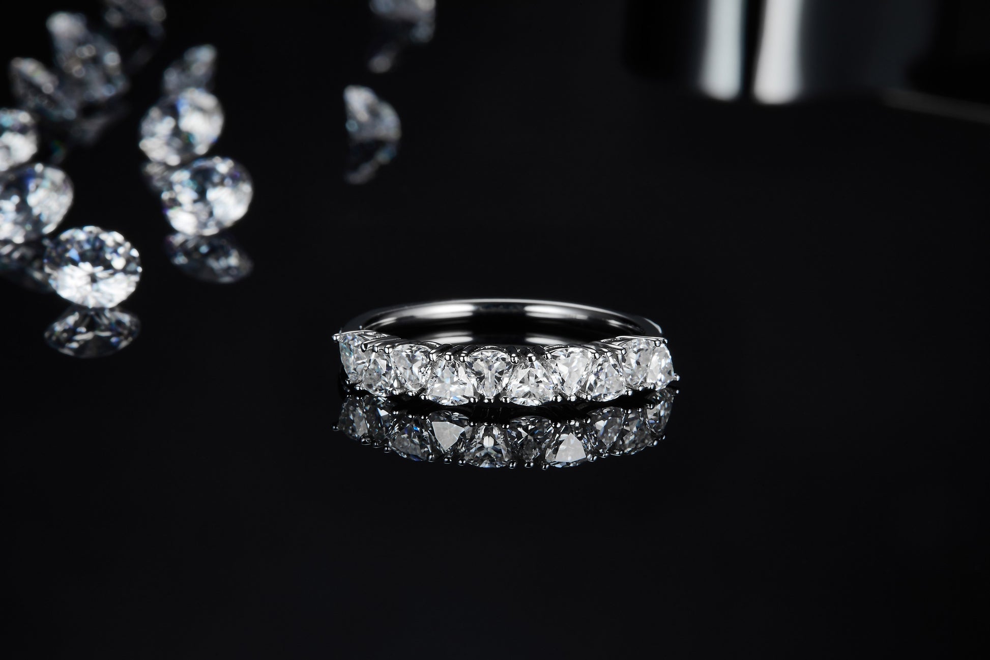 A silver trillion cut half eternity wedding ring.